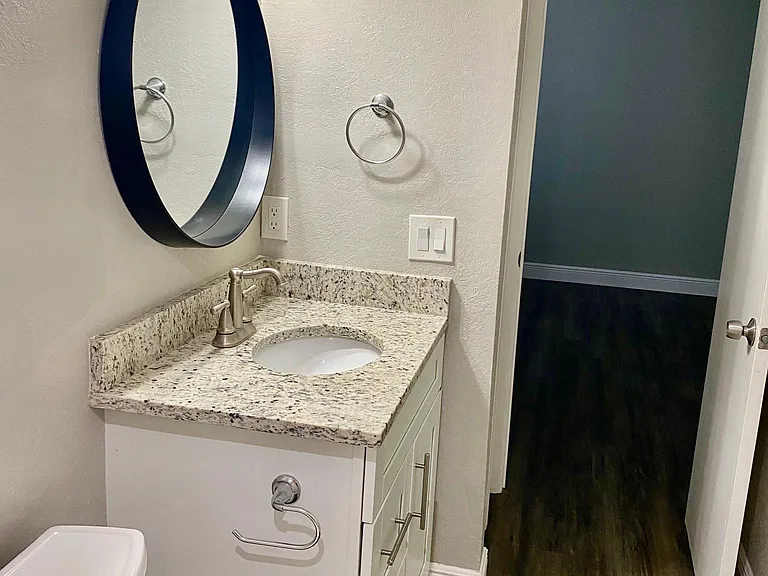Luxury bathroom with granite countertops & tons of storage. Linen closet attached for additional storage.