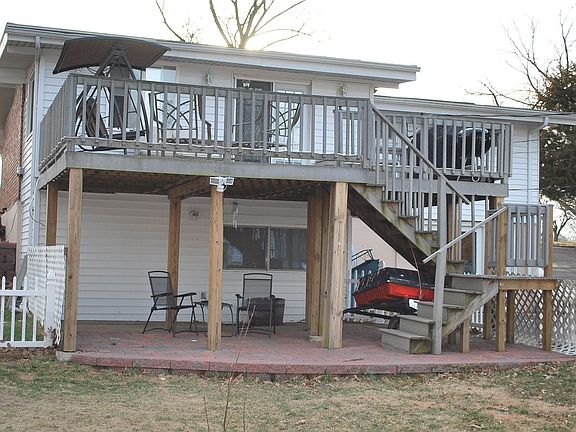 Large Deck with paved patio under. Lots of room for BBQ's