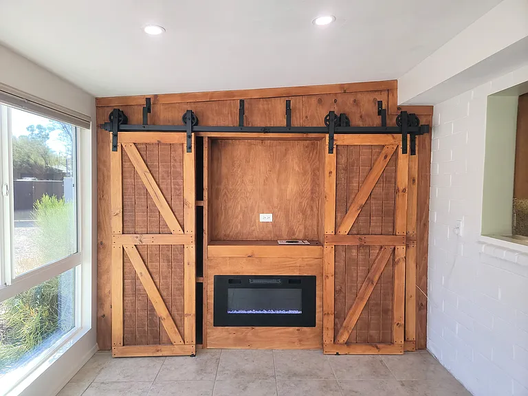 Electric Fireplace w/ TV mount in Arizona Room addition. Slides shut for additional storage.