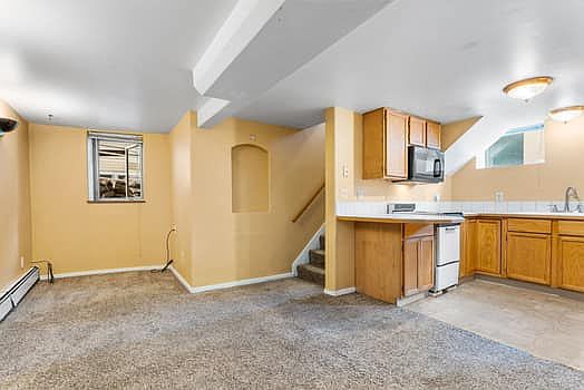 Living room and kitchen with eat in countertop area
