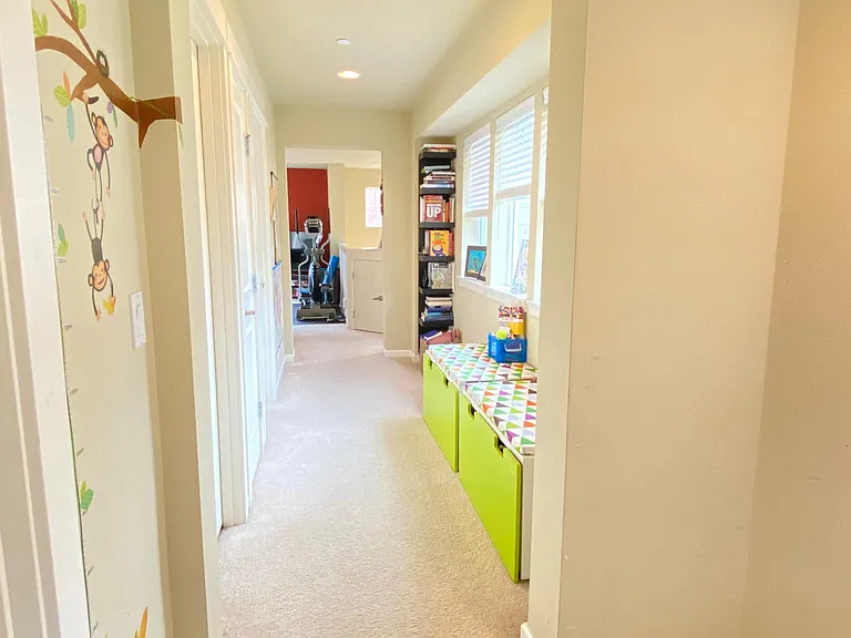 Upper level hallway with ample space for your book shelves & benches.