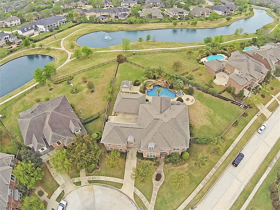 Stunning highly upgraded home on premium lake lot w/custom pool house, resort-like pool & spa and al