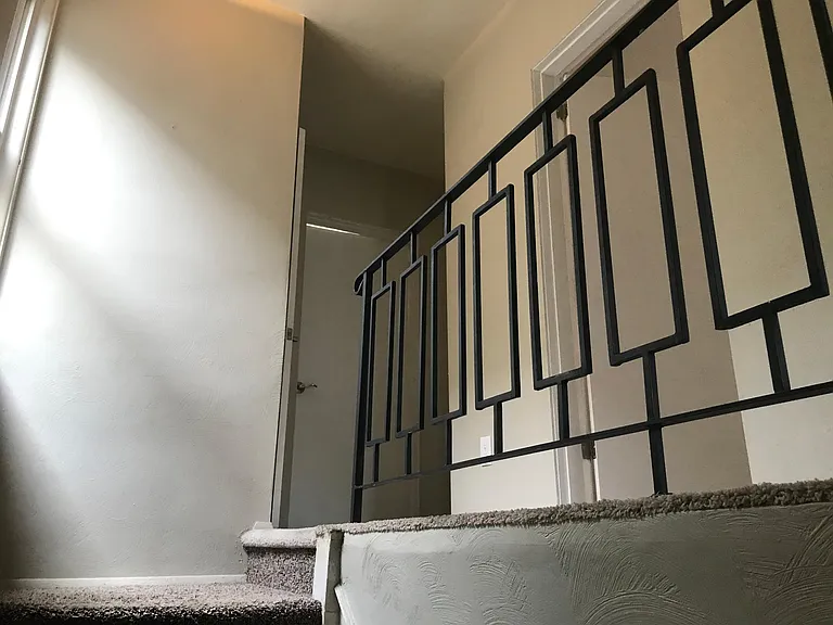 Walking up to second floor. Laundry in front and bathroom door.