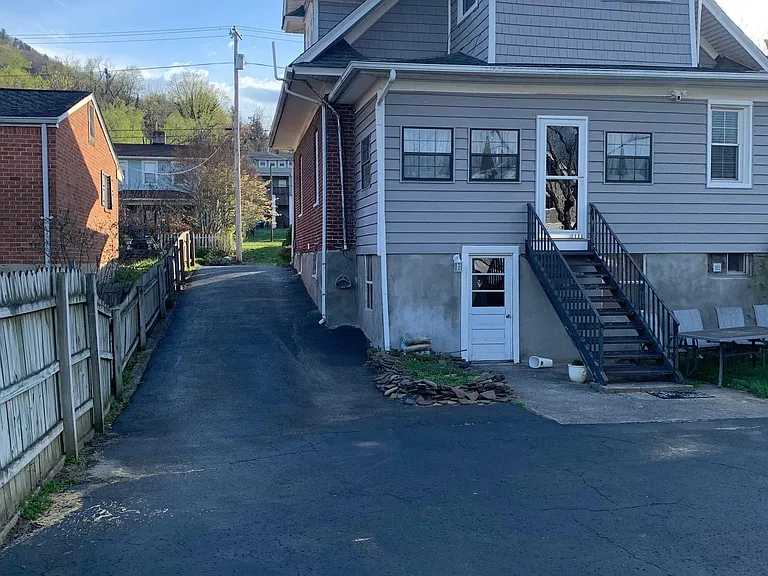 Rear of home. the bottom door goes into the unfinished part of the basement where you can keep bikes and outdoor equipment. The 2nd floor door goes into the sunroom which is right off the kitchen.