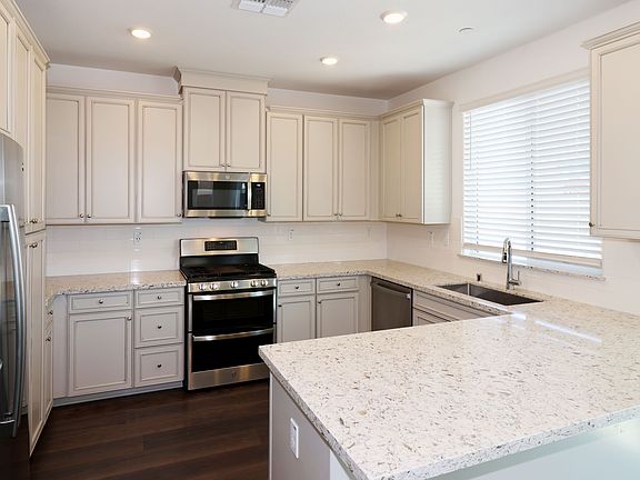 The kitchen features LED ceiling lights and a very sunny window!