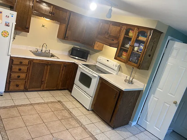 Kitchen with storage and electic stove
Coat closet door