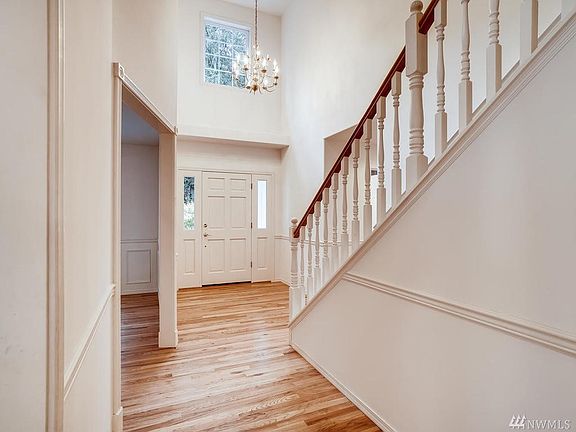 Entry boasts high ceilings, picture framing and gleaming hardwoods. 