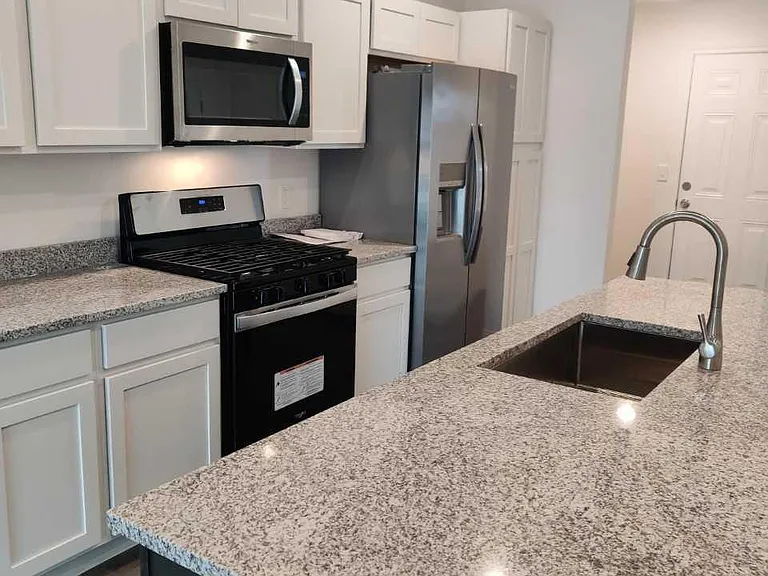 stone counter top, pull out faucet, full size microwave, pantry cabinet and more