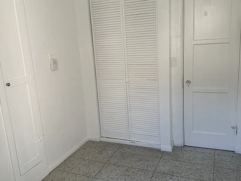 Large laundry room with new washer/dryer, walk-in pantry, built-in ironing board closet, and back door to stairs to carport
