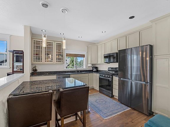 Stylish Kitchen with Granite Countertops and New Stainless Steel Appliances