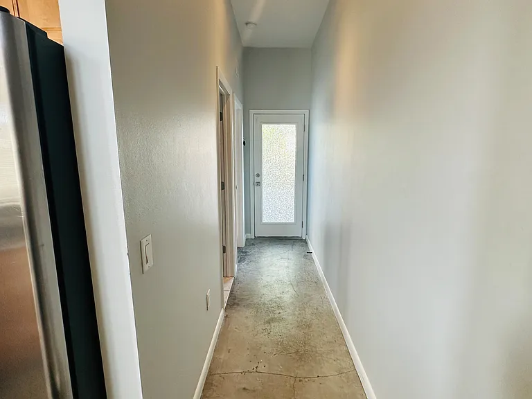 Downstairs hallway to bathroom, bedroom and back of loft entrance
