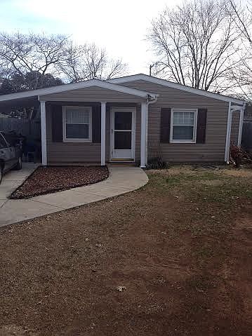Front of house with driveway parking