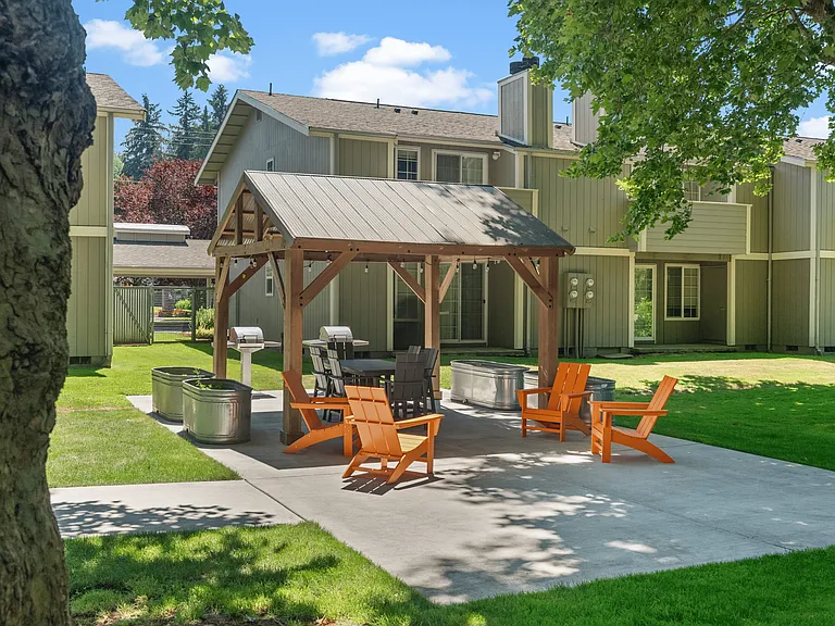 Relax and gather at the outdoor BBQ pavilion with seating and grills.