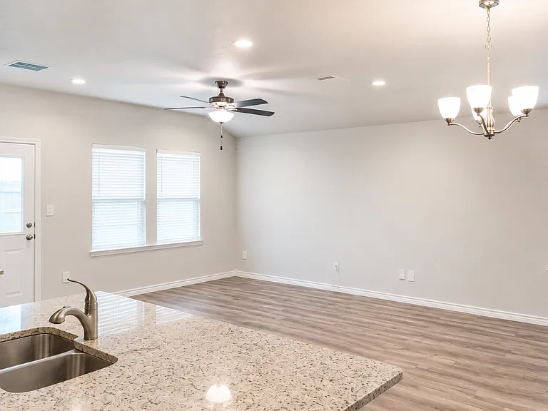 Spacious living area with wood-look flooring