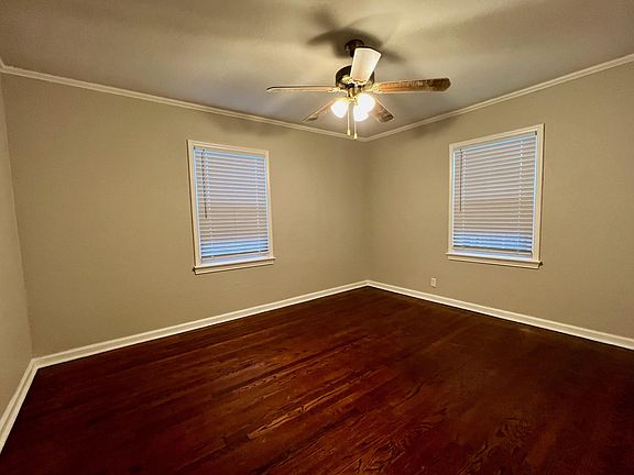 Front Bedroom Showing Refinished Hardwood Floors and New Ceiling Fan.