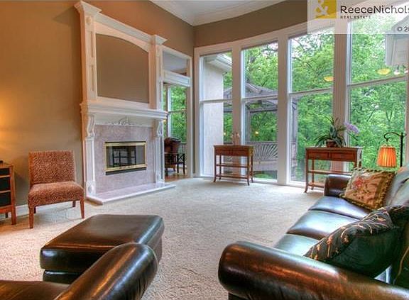 Great room with east wall of windows overlooking beautiful back yard.