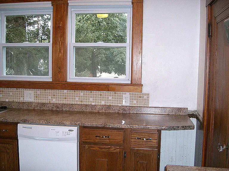 The remaining kitchen B side all the way to the back entry door