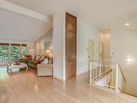 Striking interior architectural details including vaulted ceilings and skylights shine light throughout the home. 