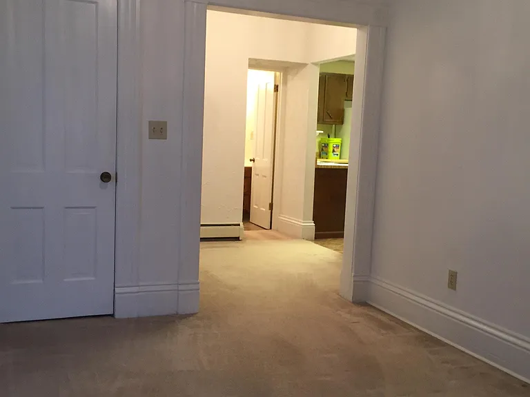 View from doorway into Living room. Porch door on left side of the entryway.