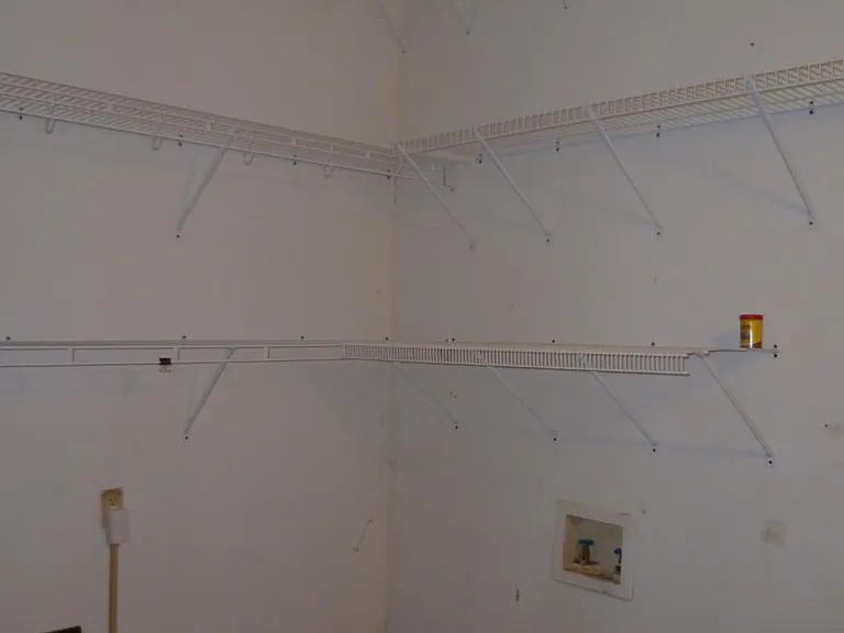 Ample storage in the utility/laundry room. The shelves wrap all the way around the room.