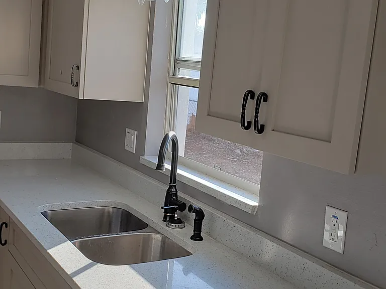 New Kitchen Cabinets and New Quartz Countertop and New Moen Faucet.
