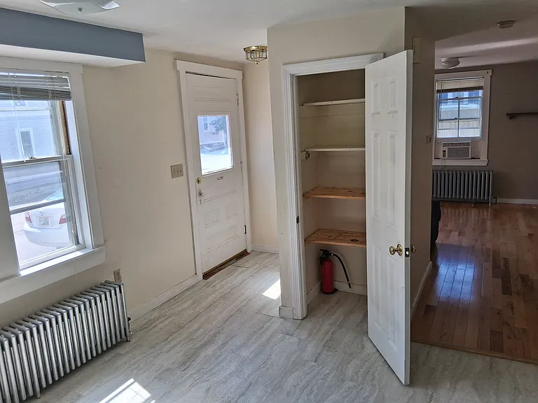 Pantry in kitchen. Living room is straight ahead. To the right (unseen here) is the half bath.