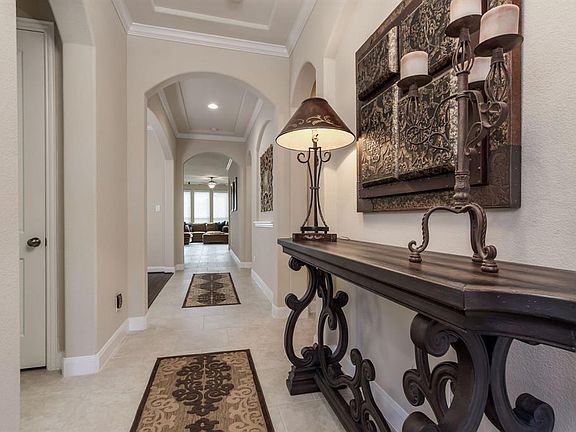 Very long entry hallway leads to spacious open family room, breakfast area and kitchen.