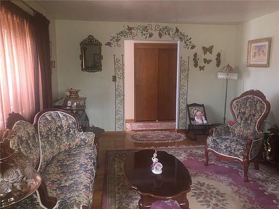 Covered front porch and beautiful bay window in living room.