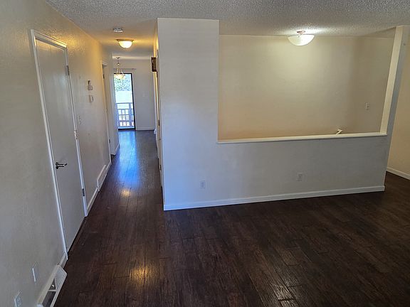 6492 Entry into living room. Door to garage is on the left. Hallway leads back to kitchen.
