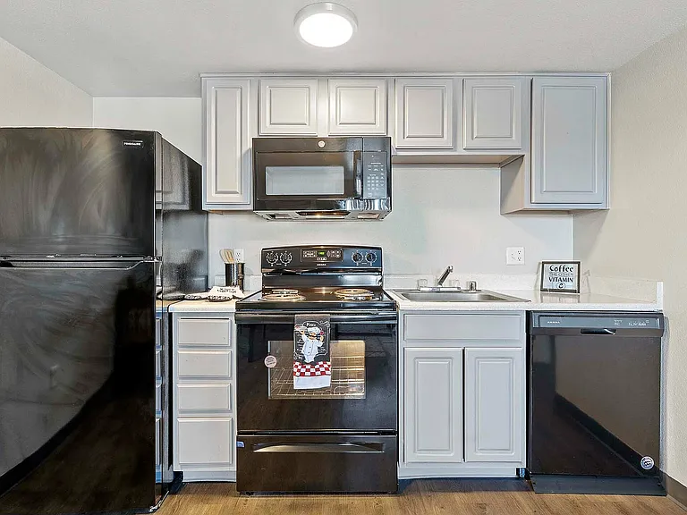 Experience contemporary cooking in this stylish kitchen equipped with essential amenities.
