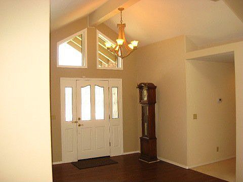 Vaulted ceiling and hardwood floor entry