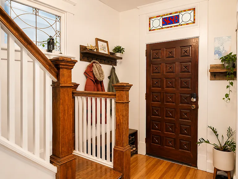 This fully-renovated home still features its original historic detail, such as the stained glass address above the front door.