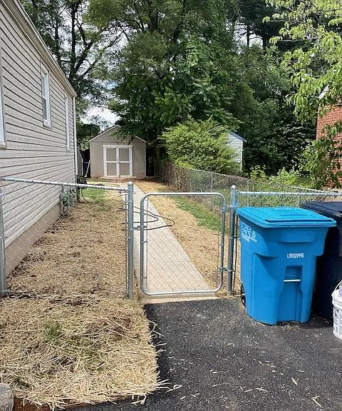 side walkway to the backyard. View of one of the storage units.