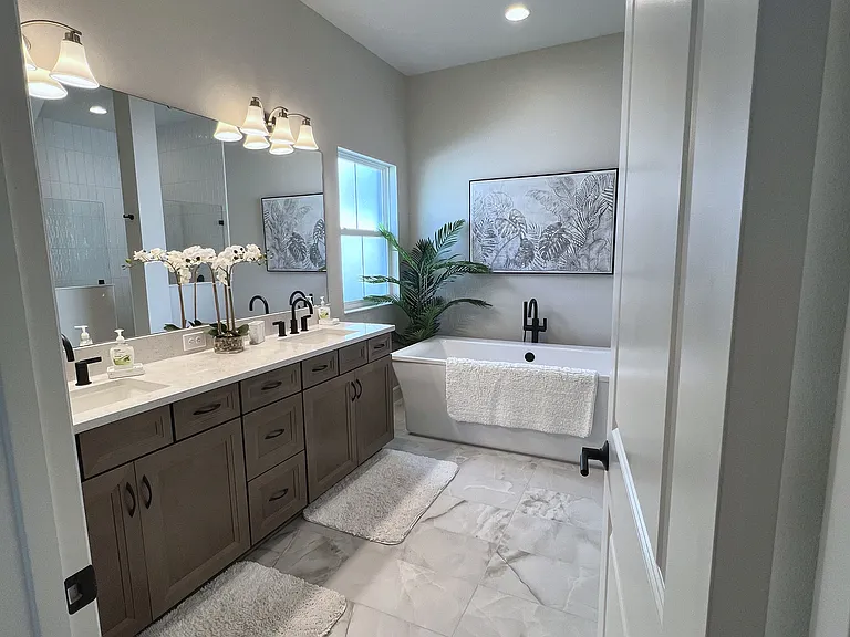 Primary bathroom with soaking tub, walk in shower and plenty of storage.