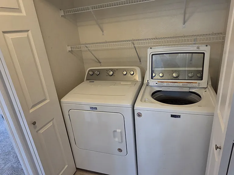 Washer and dryer with shelfing can be closed off with bi-fold dorrs