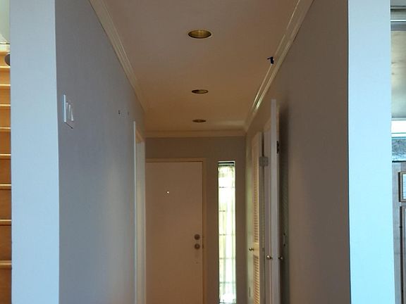 Front entrace door seen from the living room. Guest suite to the right, garage to the left.