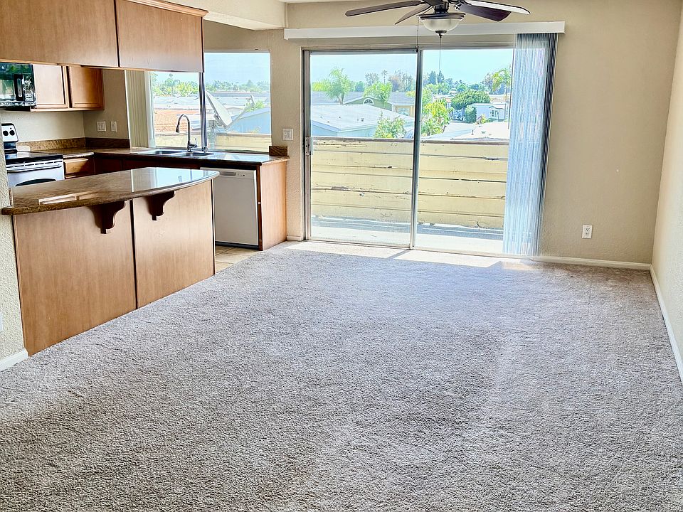 spacious living/dining room with balcony off of kitchen