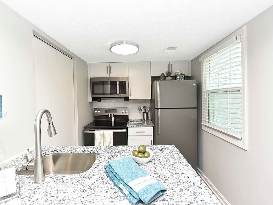 Kitchen with granite counters, modern cabinetry, and stainless appliances