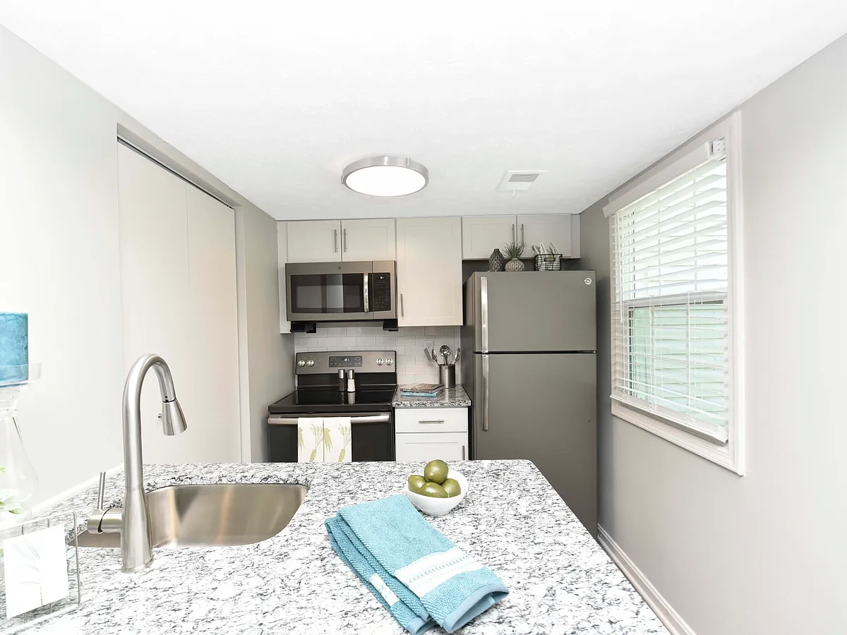 Kitchen with granite counters, modern cabinetry, and stainless appliances - Sova