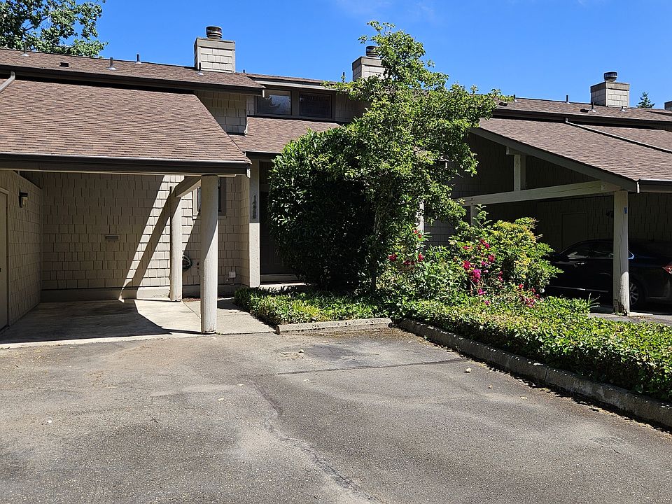 Front of home with two parking spots and one carport. Left of carport is the storage unit.