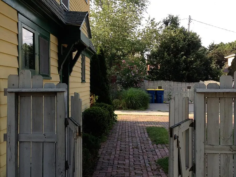 outdoor brick patio in fenced in private back yard