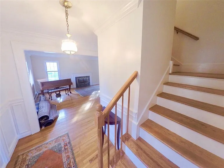 Enter front door and head upstairs or left to the living room.