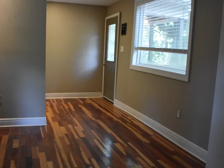 Welcoming entryway featuring beautiful hardwood floors and easy flow into the main living space.