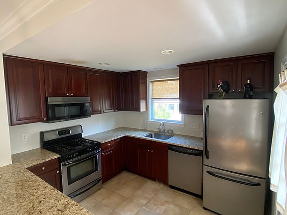 Updated appliances including gas stove, dishwasher, garbage disposal, refrigerator and microwave. 
Tile flooring and granite countertops providing an easy cleanup and elegant touch