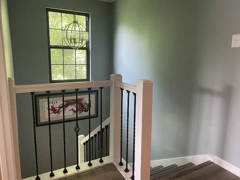 Stairway to the second floor with 3 bedrooms and 2 bathrooms.
