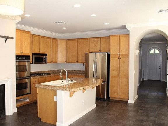 Kitchen with stainless steel appliances and granite tile