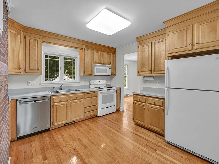 Working kitchen area. A high top table can sit in front of brick area.
