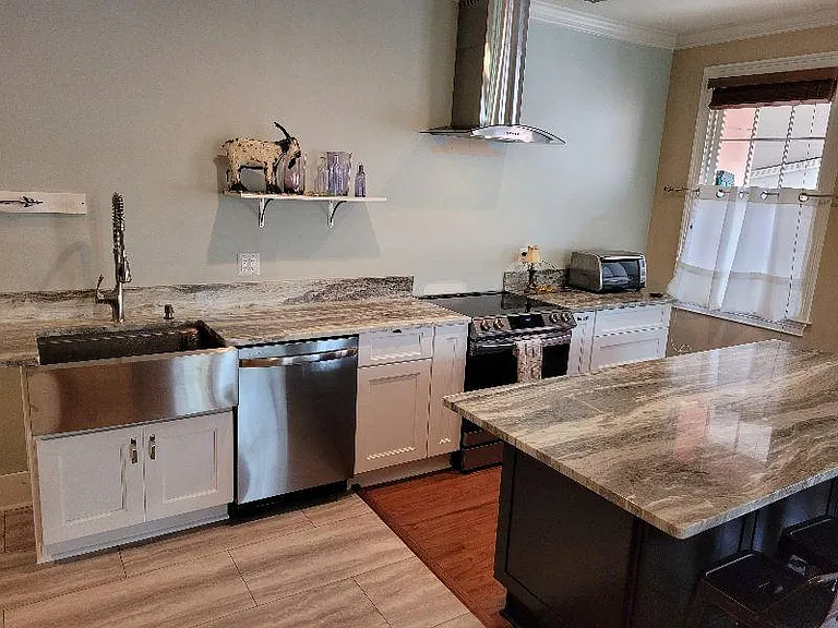 Chic new kitchen with a 7' Island all new appliances. It has everything to prepare a gourmet meal.