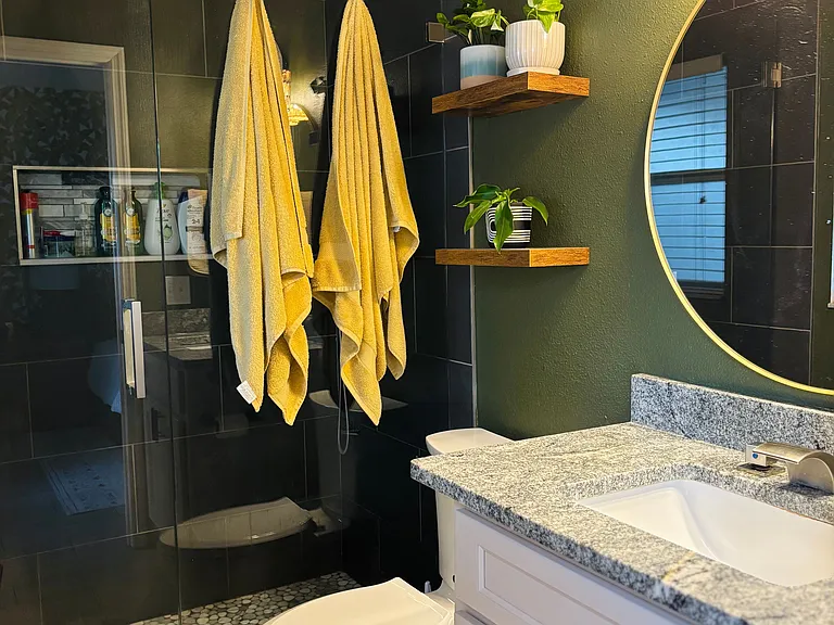 Featuring walk in shower with luxurious rainfall shower head.