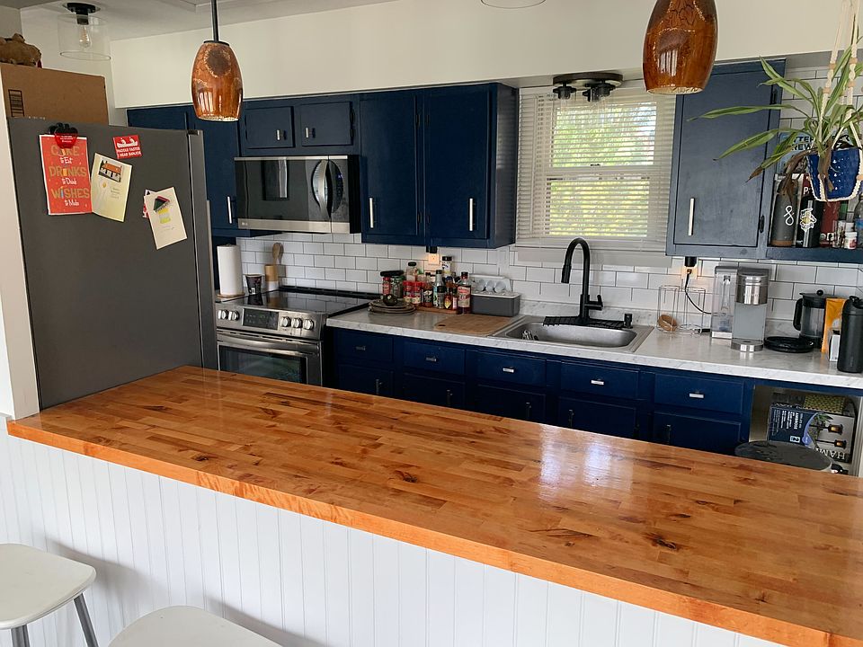 Updated kitchen with modern stainless-steel appliances including; full size fridge/freezer, microwave, electric-oven, and dishwasher.